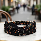 Bandeau cheveux AuroraFlora noir présenté en gros plan sur table.