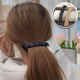 Barrette cheveux CrystalMuse brillante maintenant une queue basse chic.