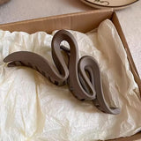 Pince à cheveux WaveSculpt en gros plan dans sa boîte d’emballage.