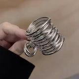 Pince cheveux MetalTwist argent clair finition métallique présentée en gros plan.