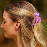 Pince cheveux Soft Hold rose portée sur une coiffure féminine, permettant de maintenir les cheveux en place tout en ajoutant une touche élégante.