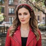Serre tete SpikeAura rouge maintenant les cheveux d’une femme avec un style rock moderne.